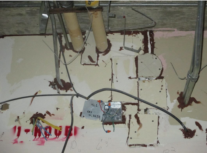 Open junction box, patched barrier areas, and untreated head-of-wall joint.